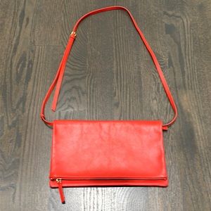 Red leather fold over bag. Crossbody strap.